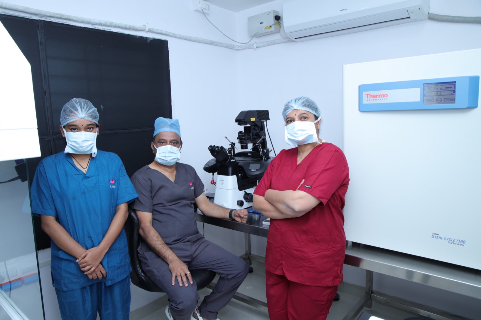 Srishti SAFE embryology team in the IVF laboratory beside the Nikon workstation and Thermo incubator