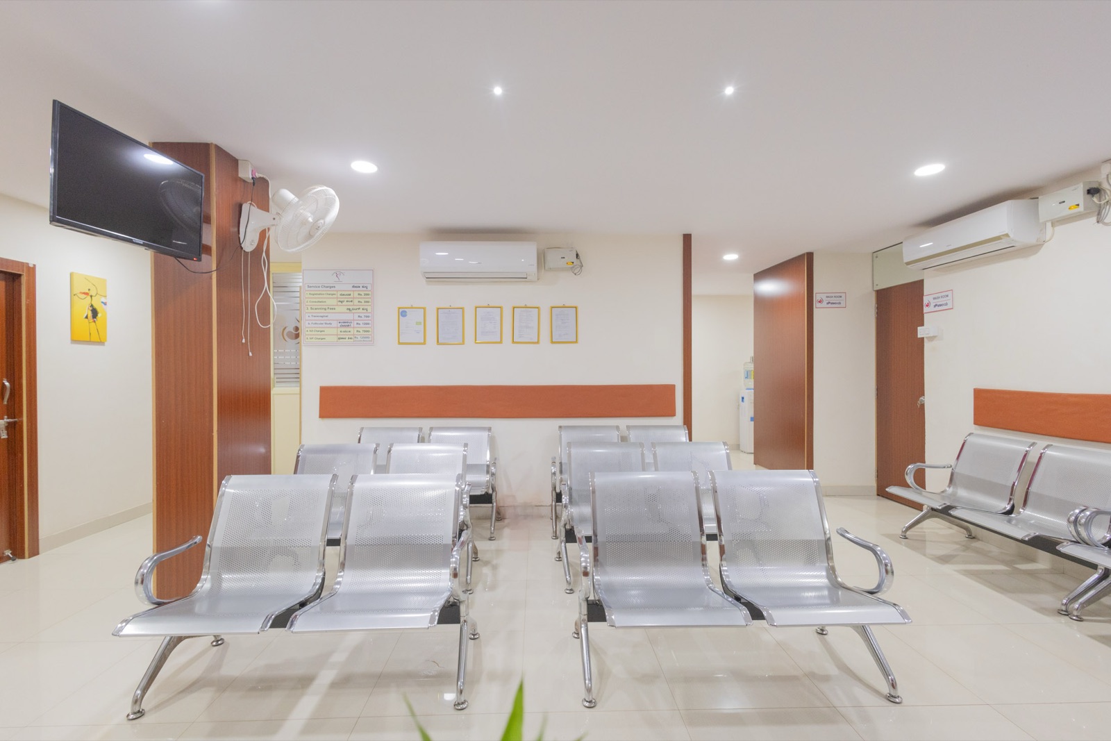 Service charges and treatment rates posted on the waiting area wall at Srishti SAFE